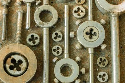 Threading dies on a rusty background Stock Photos