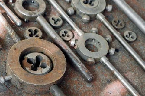Threading dies on a rusty background Stock Photos