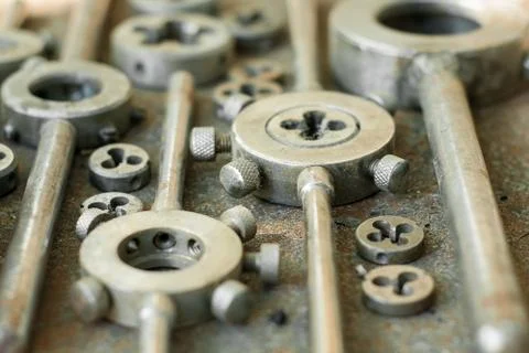 Threading dies on a rusty background Stock Photos