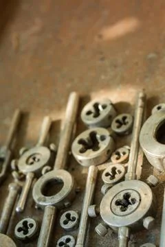 Threading dies on a rusty background Stock Photos