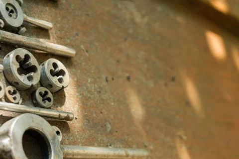 Threading dies on a rusty background Stock Photos