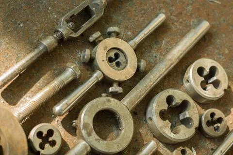 Threading dies on a rusty background Stock Photos