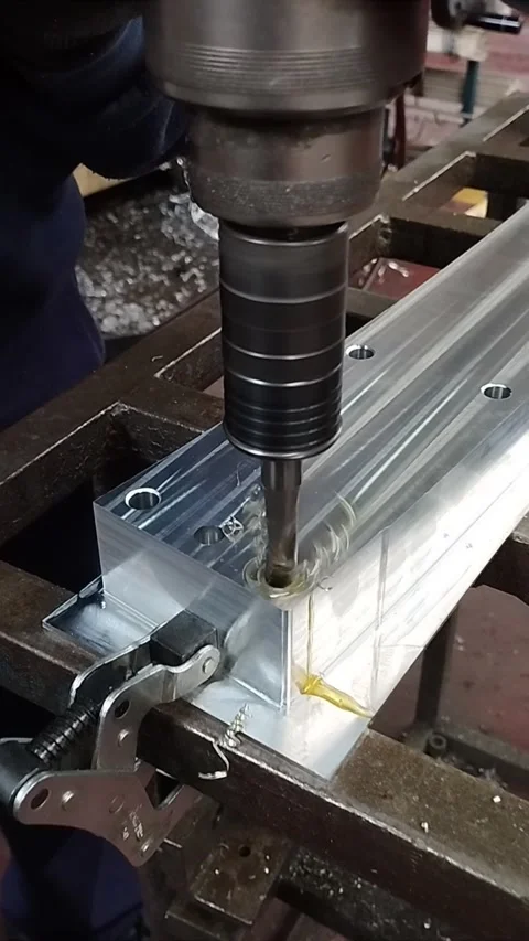 Threading a drill into an aluminum part. Machining workshop. Stock Footage 267972882