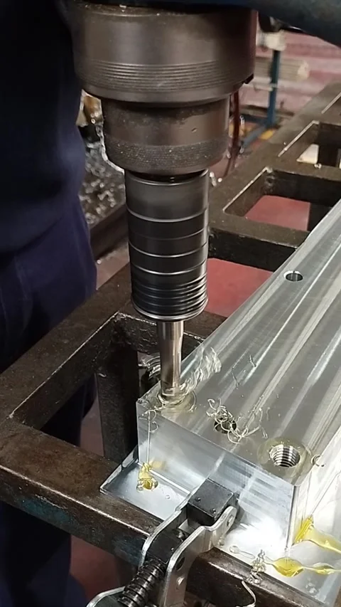 Threading a drill into an aluminum part. Machining workshop. Stock Footage 267972891