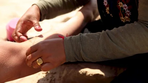 Threading - epilation procedure for legs on the beach Stock Footage 233500663