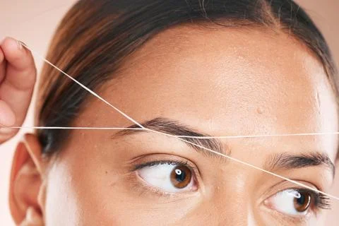 Threading, eyebrows and beauty with a model black woman in studio on a beige Stock Photos