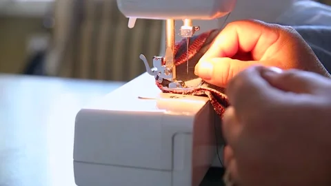 Threading a needle on an electric sewing machine, home appliance in use Stock Footage 141533019