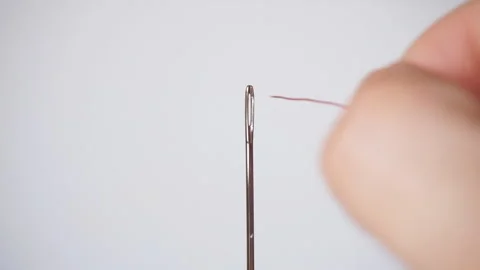 Threading a needle for hand sewing. Sewing needle closeup Stock Footage 109182370