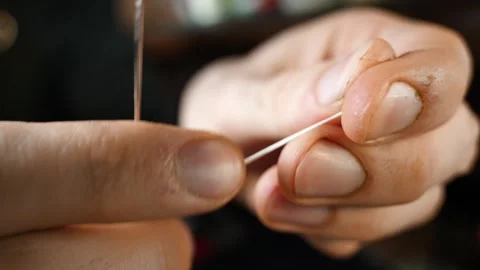 Threading needle for leather stitching Stock Footage 314961697