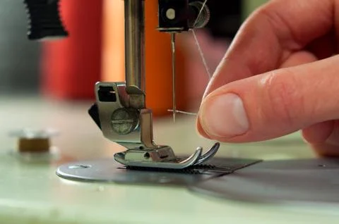 Threading the needle in a sewing machine Stock Photos