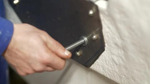 Threading nyloc nut onto stainless steel bolt Stock Footage 331222097