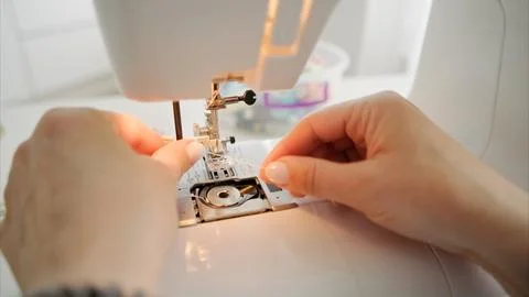 Threading a sewing needle Stock Photos