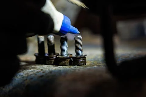 Threadlocker Applied to Rusted Bolts with Blue Tip Applicator Macro Stock Photos