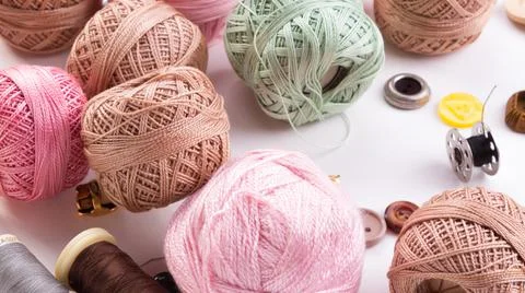 Threads and buttons on white background. Stock Photos