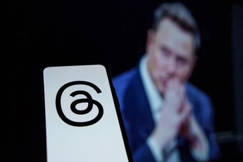 Threads and instagram app logo on screen, Twitter CEO Elon Musk in the Stock Photos