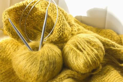 Threads and knitting needles. Knitting blankets. Knitted sweater. Needlework  Stock Photos