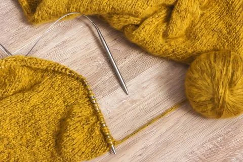 Threads and knitting needles. Knitting blankets. Knitted sweater. Needlework  Stock Photos