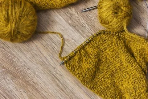 Threads and knitting needles. Knitting blankets. Knitted sweater. Needlework  Stock Photos