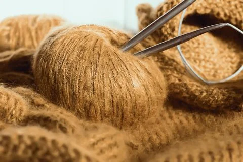 Threads and knitting needles. Knitting blankets. Knitted sweater. Needlework  Stock Photos