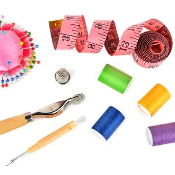 Threads and sewing accessories isolated on white background. Sewing pattern. Stock Photos