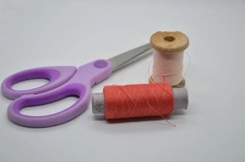 Threads and spools for sewing clothes on a white background Stock Photos