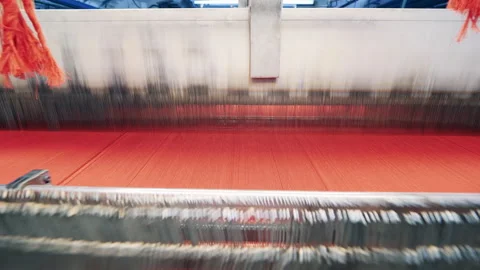 Threads are getting used by a weaving machine to make fabric Stock Footage 159800314