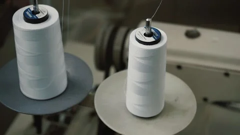 Threads are wound from the spool of the sewing machine Stock Footage 130507363