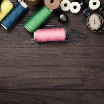 Threads buttons and needles on the table Stock Photos