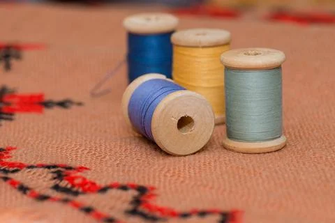 Threads, coils. Multicolored threads on the canvas Stock Photos
