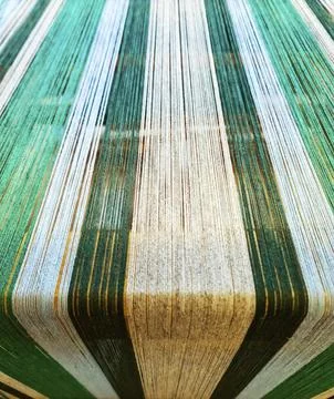 Threads creating textile fabric on a loom warping machine Stock Photos