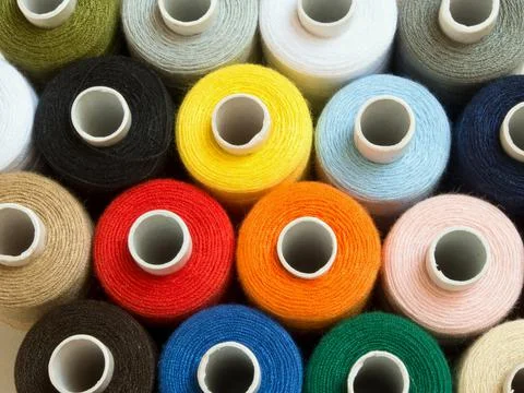 Threads of different colors on spools, standing vertically,top view,close up Stock Photos