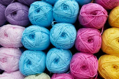 Threads for knitting different colors on the shelf in the store. Close up Stock Photos