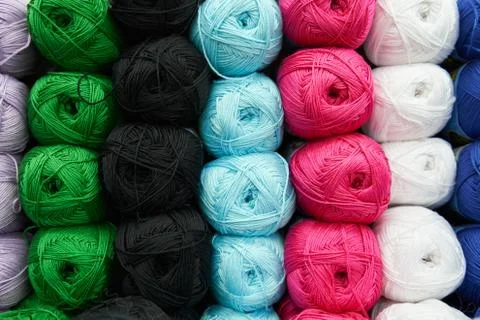 Threads for knitting different colors on the shelf in the store. Close up Stock Photos
