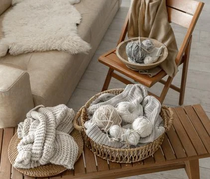 Threads for knitting in the interior of the room, a cozy composition with yarn. Stock Photos