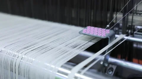 The threads on the knitting machine are weaving Stock Footage 165041397