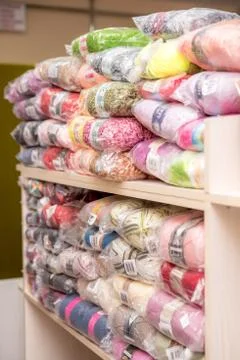 Threads for knitting in the needlework store. Stock Photos