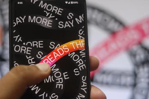 The threads logo is displayed on a smartphone screen. Threads new social ne.. Stock Photos