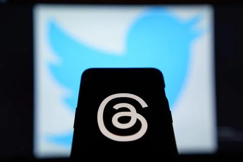 Threads logo on screen, Twitter logo in the background Stock Photos
