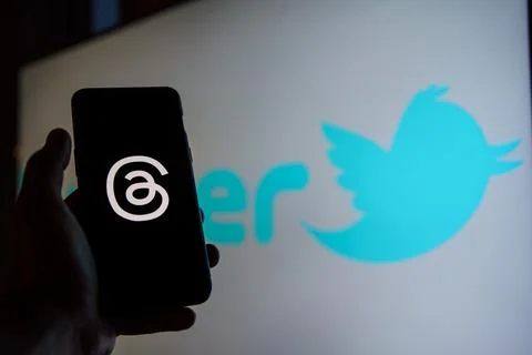 Threads logo on screen, Twitter logo in the background Stock Photos