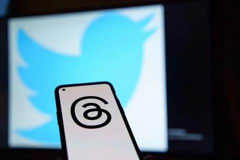 Threads logo on screen, Twitter logo in the background Stock Photos