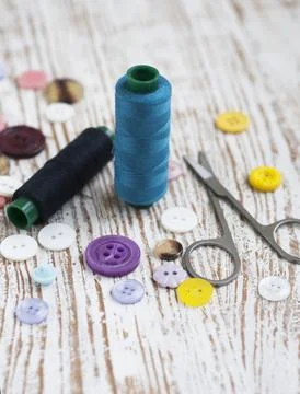 Threads, measuring tape on a satin background Stock Photos