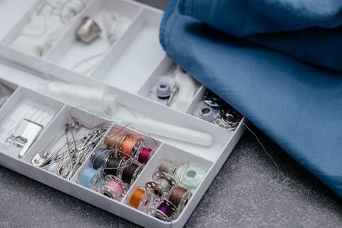 The threads of the needle lie in the sewing box. close-up sewing preadees lie in Stock Photos