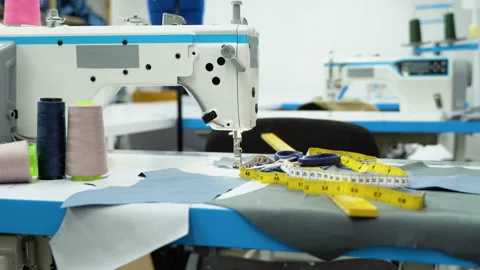Threads, pattern, scissors, tape measure, and a sewing machine. Workplace of Stock Footage 230924456
