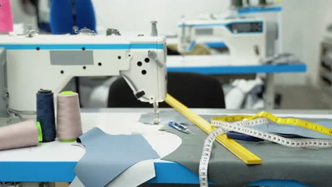 Threads, pattern, scissors, tape measure, and a sewing machine. Workplace of Stock Footage 230939276