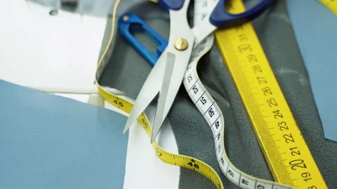 Threads, pattern, scissors, tape measure, and a sewing machine. Workplace of Stock Footage 230939381