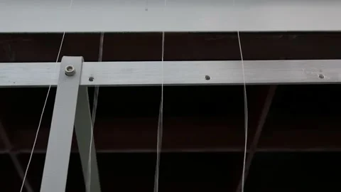 Threads that run from the spools on which they were wound and go to the weav Stock Footage 148341131