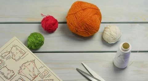 Threads for sewing clothes and needlework on a wooden surface Stock Photos