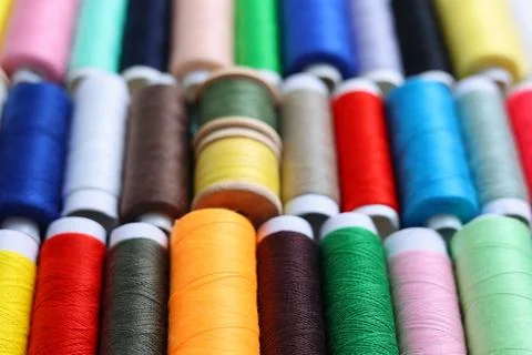 Threads for sewing in different colors on a colored background Foto stock