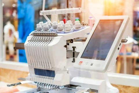 Threads on a sewing machine in loops from spools during automatic operation. Stock Photos