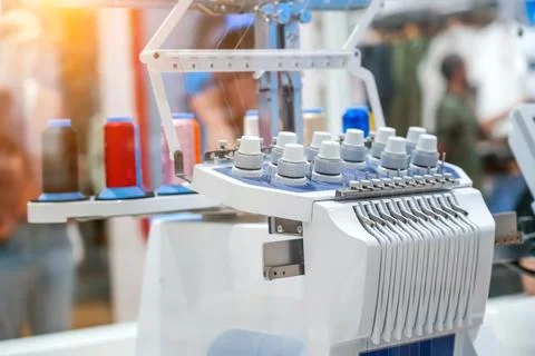 Threads on a sewing machine in loops from spools during automatic operation. Stock Photos